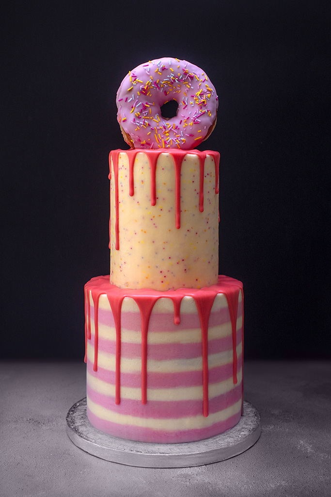Two-tier donut cake with pink dribble icing